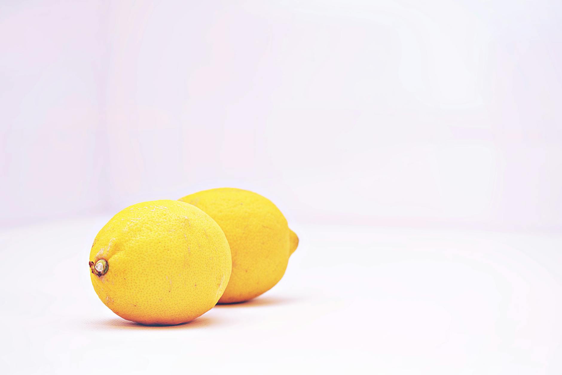 Two bright lemons against a white background symbolizing the fresh, unpredictable nature of pleasure