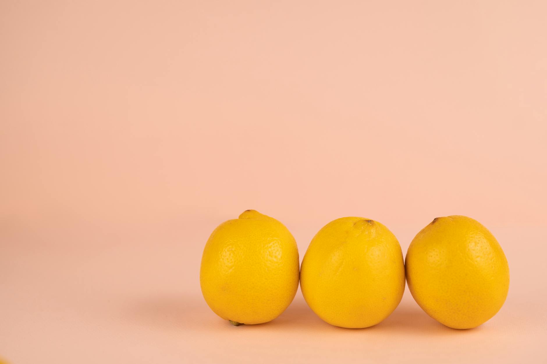 Bright ripe lemons on a pastel background, symbolizing gentle healing and renewal